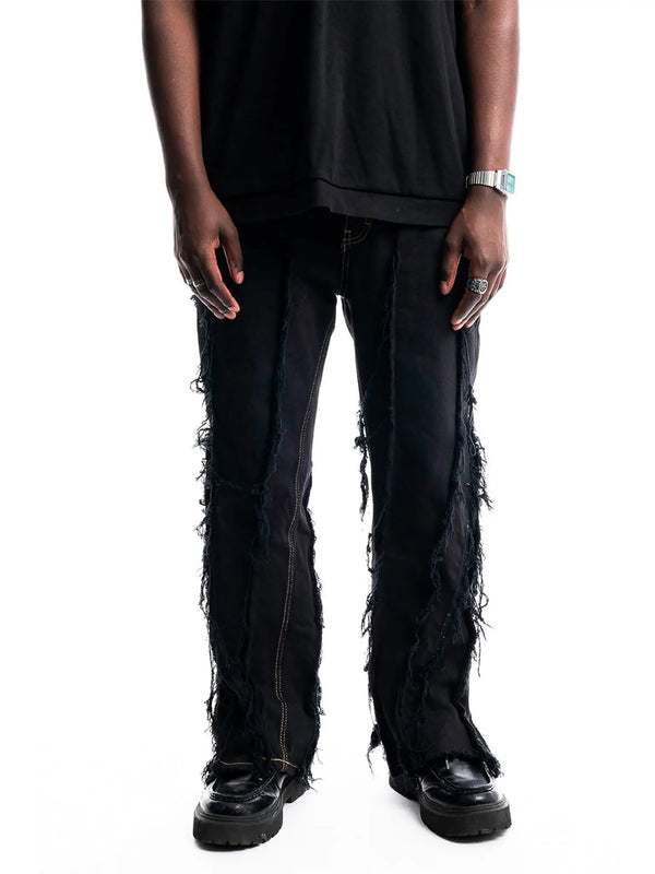 Black Ripped Denim — close-up on seams, tears, and fabric texture Detail