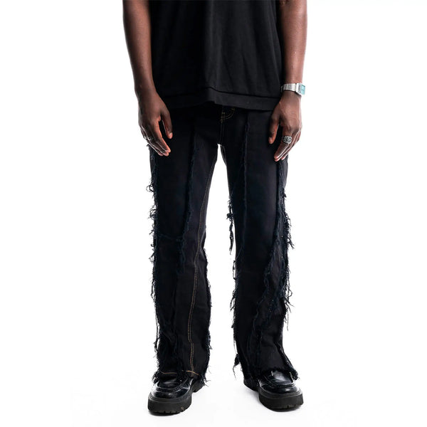 Black Ripped Denim — close-up on seams, tears, and fabric texture