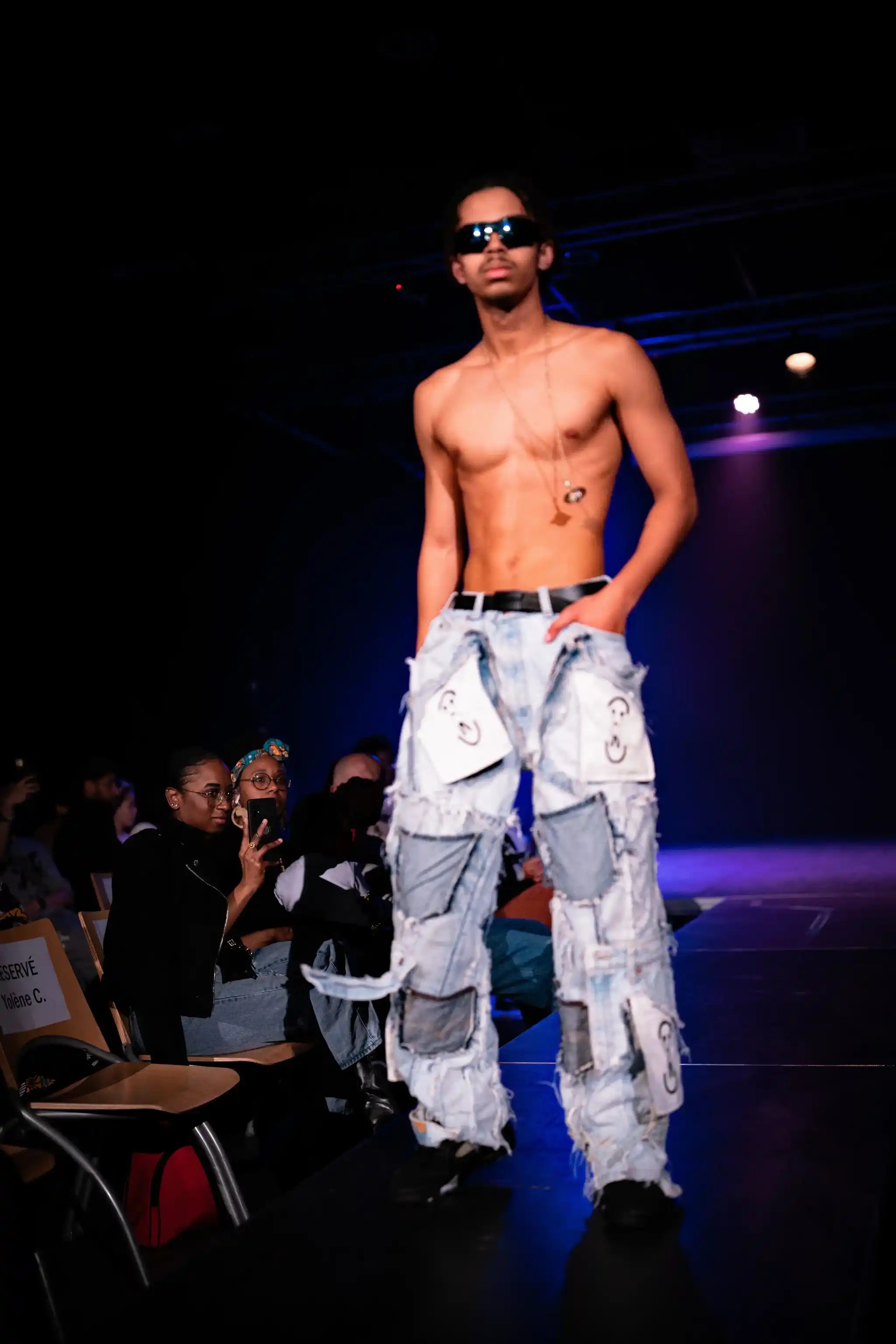 Fashion show: model wearing PrototypesParis Patchwork Relic Denim —light-wash upcycled denim, front view.